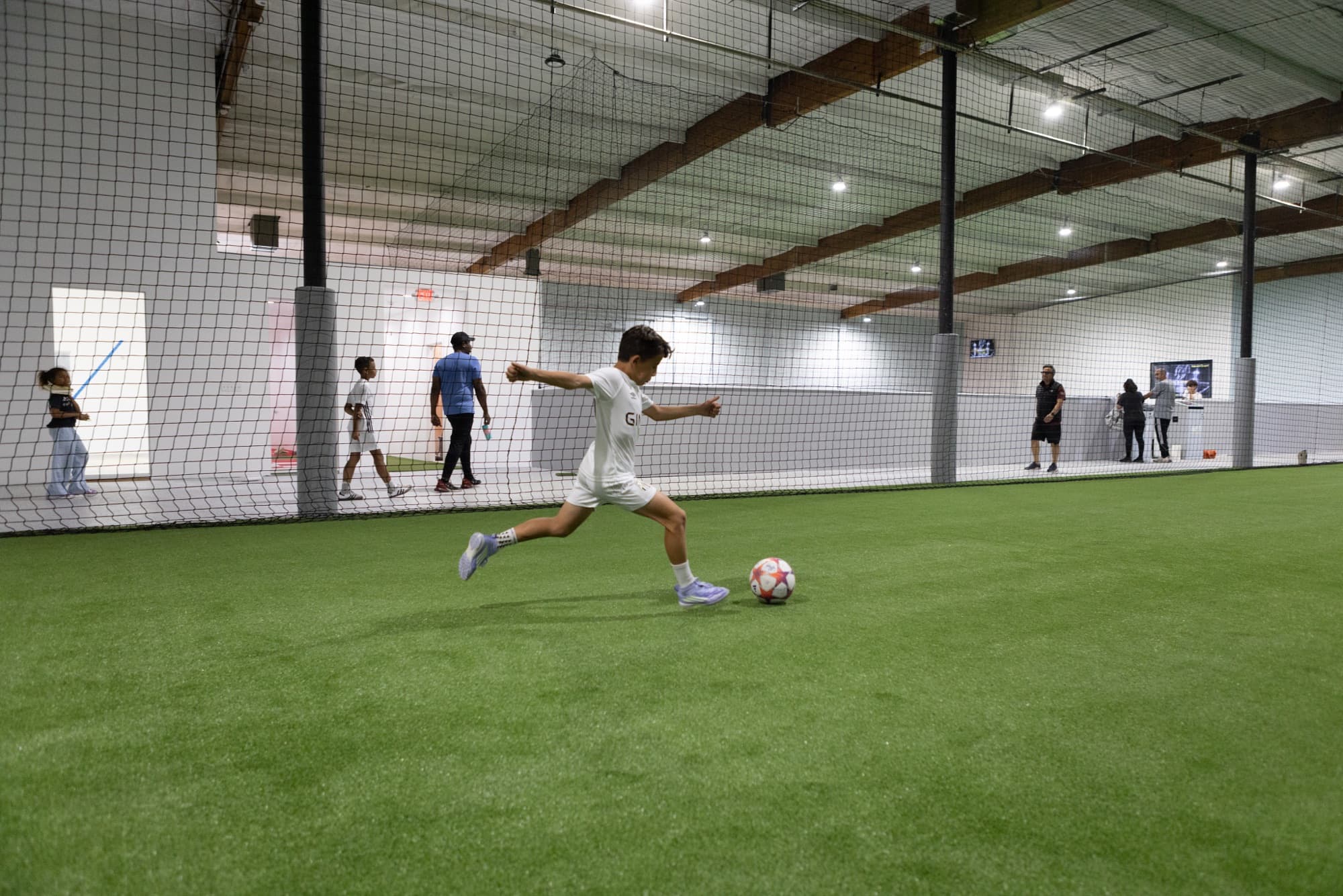 Players training on an indoor turf field at Formula Soccer Center.